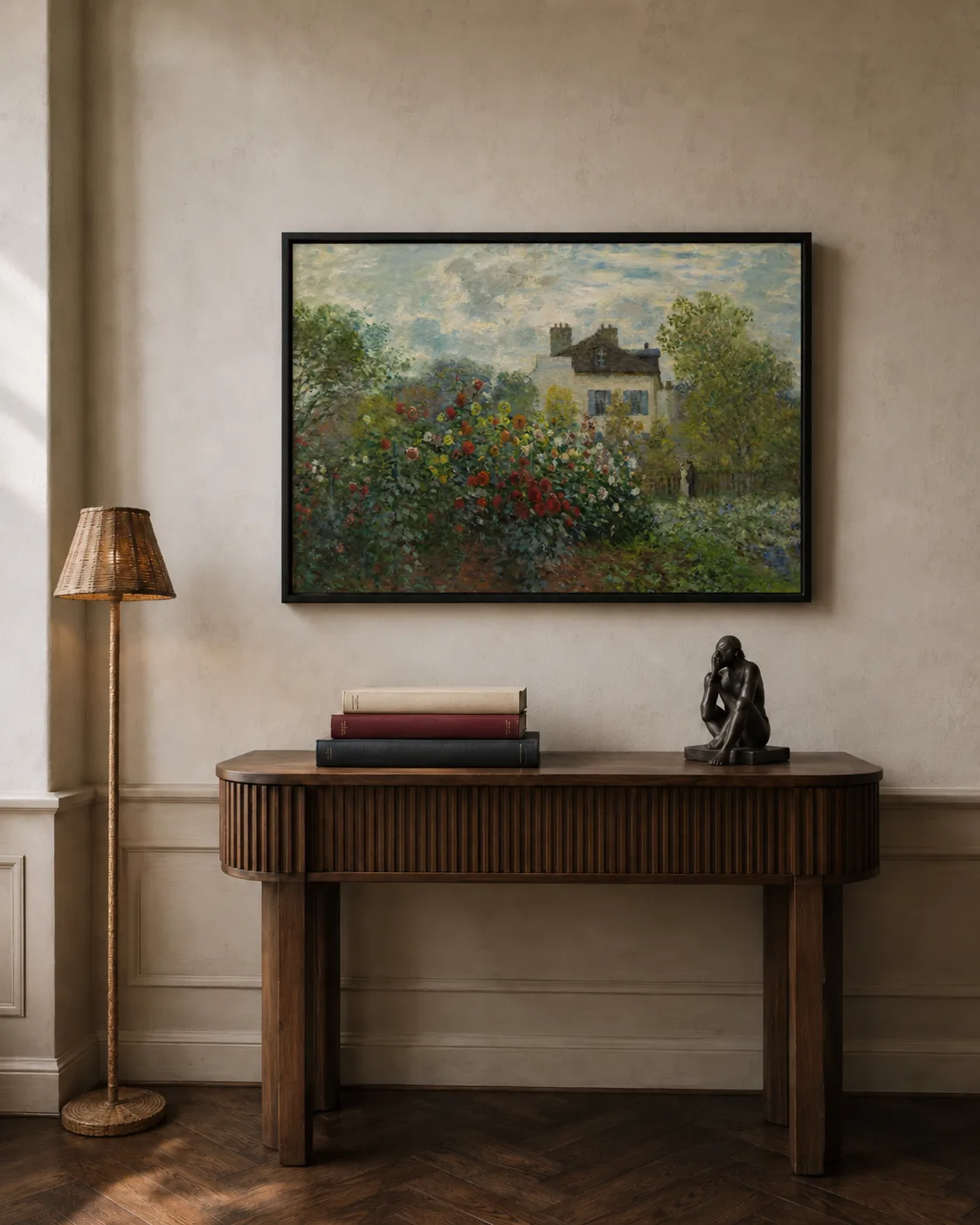 A framed Monet garden print above a fluted walnut console with art books and a slim floor lamp